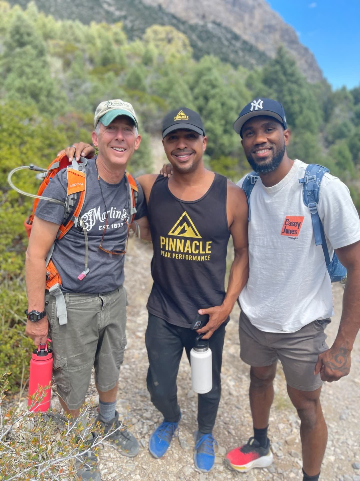 John Hall on a mountain trail with two other hikers